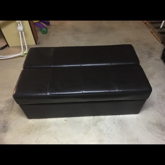 Black leather ottoman pulls out to a single bed.
